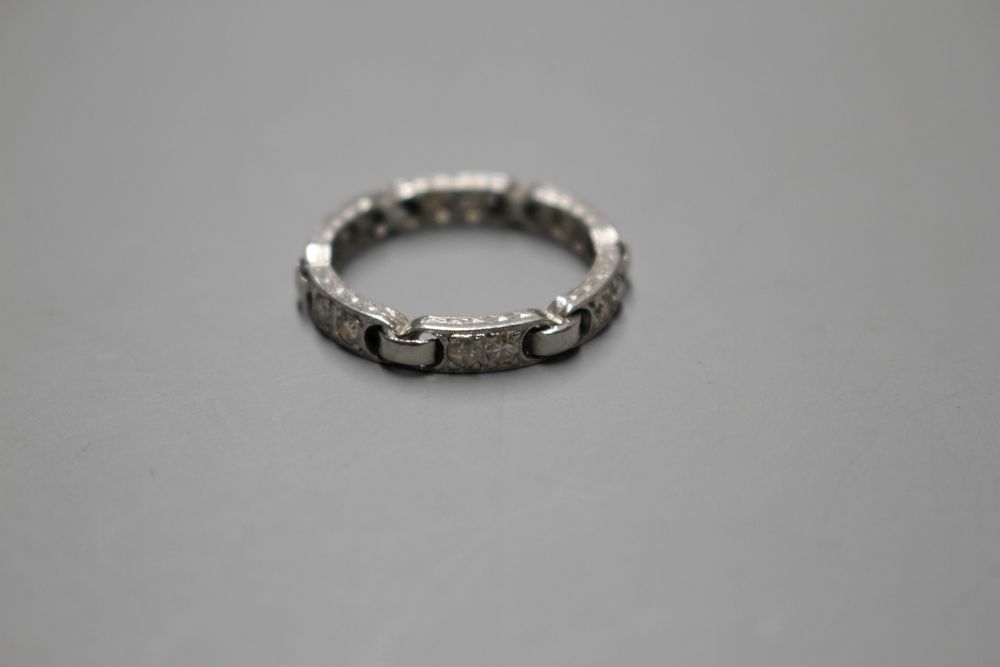 An unusual white metal (stamped Plat) and twelve stone diamond set eternity ring,